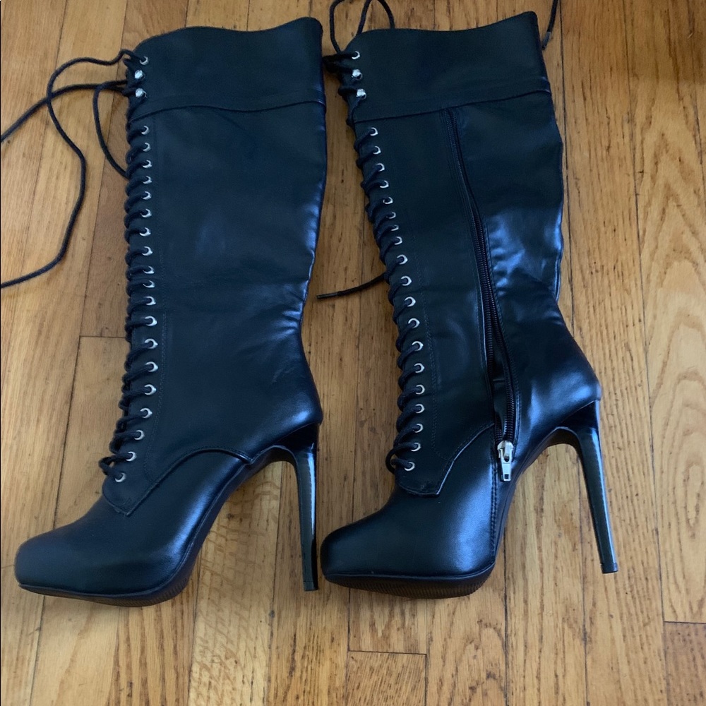 Brand new high heeled black tie boots never worn
